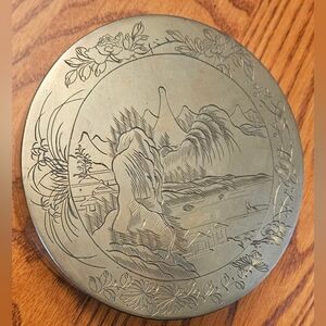 Antique Metal circular trinket box with heavy metal inner lid.